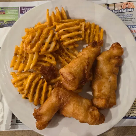Fried shrimp served with waffle fries and dipping sauce