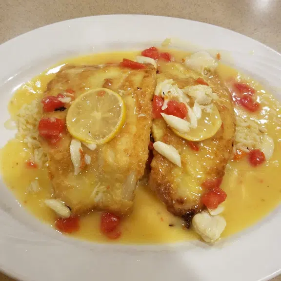 Lemon butter fish fillet topped with fresh tomatoes
