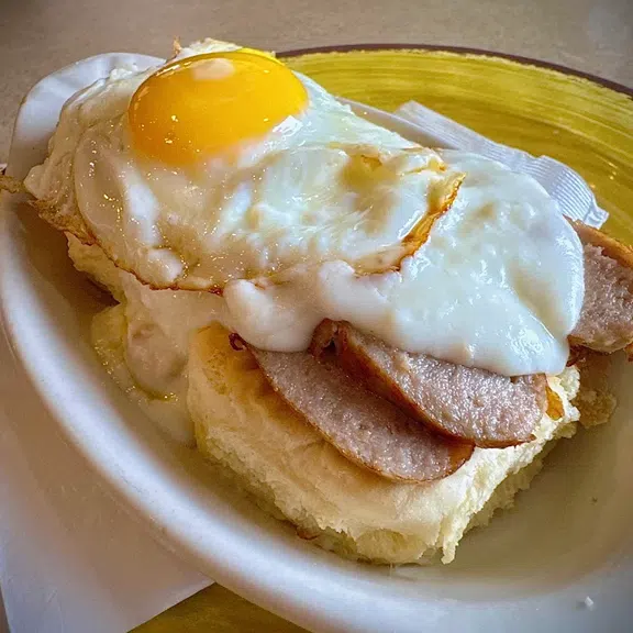 Breakfast sandwich with fried egg and breakfast meat